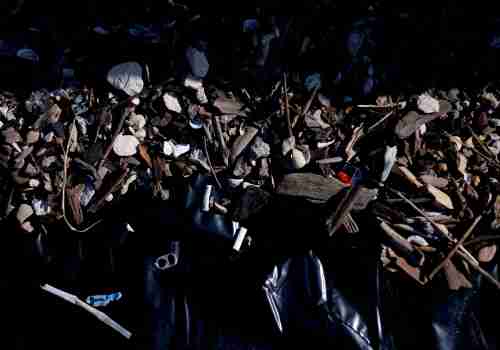 Bits of plastic, straw wrappers and pop tabs are mixed up with sand, driftwood and stones. 